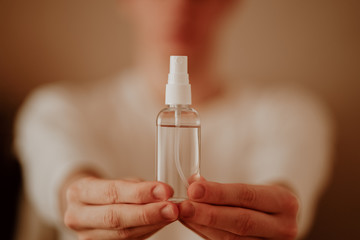 Man in protective mask and with antibacterial antiseptic gel for hands disinfection and health protection prevention during flu virus outbreak, epidemic and infectious diseases