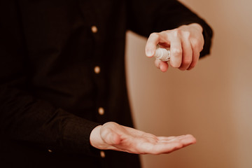 Man in protective mask and with antibacterial antiseptic gel for hands disinfection and health protection prevention during flu virus outbreak, epidemic and infectious diseases