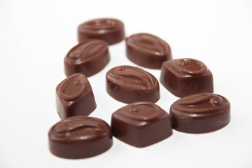 Assortment of delicious chocolate candies isolated on white background.