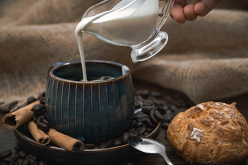 cup of coffee with pouring milk