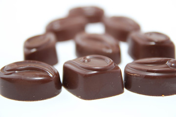 Assortment of delicious chocolate candies isolated on white background.