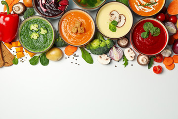 Vegetable soups and ingredients on white background, space for text