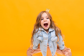 stylish young girl posing isolated on a yellow studio background