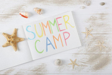 The inscription "summer camp" on a colored background top view.