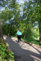 Fototapeta na wymiar Woman on a morning run in the park.