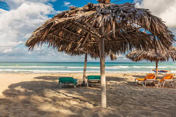 Varadero beach, Cuba - Huts made of straw on the beach of Varadero for shading from the sun