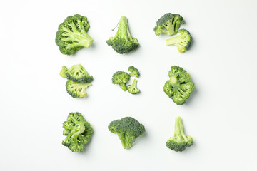 Flat lay with broccoli on white background, top view