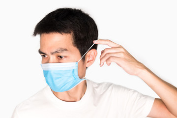 Asian man wearing face mask for protect corona virus and air pollution, pm 2.5, on white background. Medical and healthcare concept