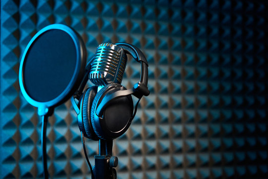 Retro microphone and pop filter on acoustic foam panel background