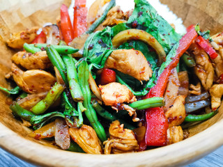 Wok rice cooked with soy sauce, vegetables and chicken pieces.