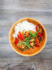 Wok rice cooked with soy sauce, vegetables and chicken pieces.