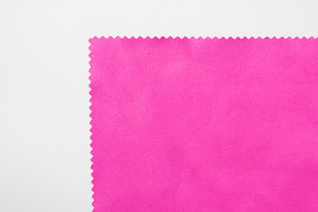 Violet fabric texture detail isolated on white background. Velvet purple or soft pink color material, textile clothing design fragment 