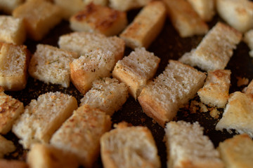 Rusks in the pan. Homemade toasted bread, croutons. Bread in salt, pepper, seasoning, crunchy salad.