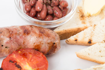 Fragment of english breakfast with the sausage.