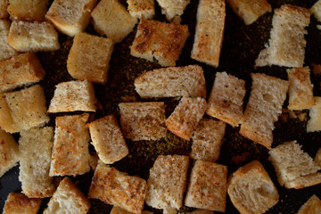 Rusks in the pan. Homemade toasted bread, croutons. Bread in salt, pepper, seasoning, crunchy salad.