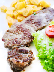 juicy steak beef meat with tomato and potatoes