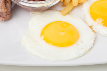 Fragmnet of the breakfast with fried eggs.