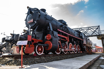 Fototapeta na wymiar Steam locomotive and blue sky in the background
