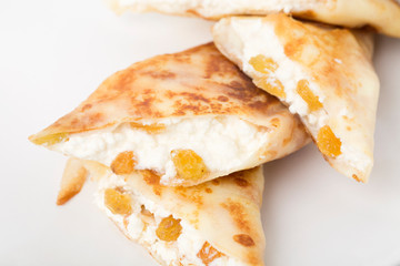 Pancakes stuffed with cottage cheese and raisins.