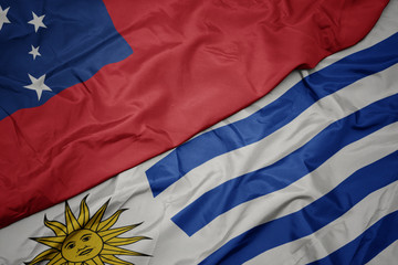 waving colorful flag of uruguay and national flag of Samoa .
