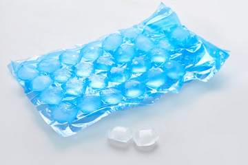 Blue plastic packaging ice bags for home water freezing. Ice cubes in plastic bags,  freezer for...