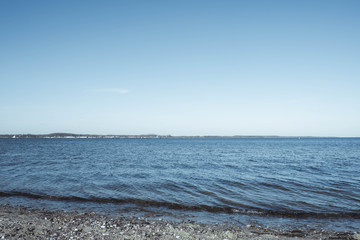 Obraz premium rocky seashore, blue sky and blue sea