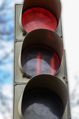The traffic light shows red, which prohibits traffic for people.