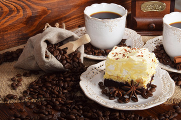 retro cups with hot coffee and a cookie with vanilla chocolate cream