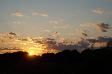 Sunset silhouette of church cross at sunset.