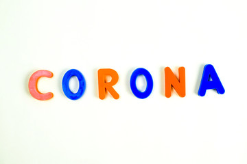 CORONA word written in various colored letter blocks on a white background