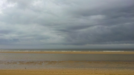 empty beach and sea against stormy sky in Zandvoort, Netherlands