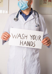 Doctor holding Wash your hands sign. Anti nCoV Covid-19 Virus