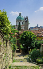 Steep street in Brescia, view of the dome Catedral of Santa Maria Assunta. Italy. Soft focus blurred background/