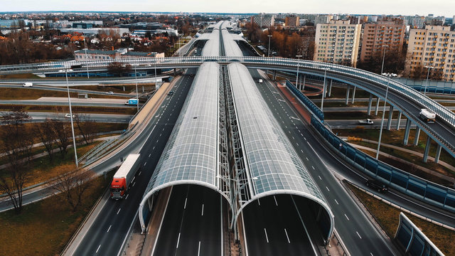 Warsaw, Poland, 03.20.2020. - The anti-noise glass tunnel and overpass Trasa Torunska highway in north-east Warsaw.