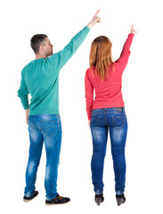 Back view of couple in sweater pointing.