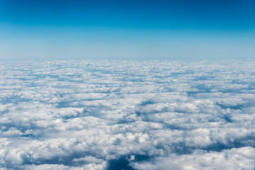 Top view of white clouds above the ground or water