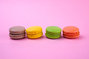 Traditional macaroon macaroon cookies on a pink background