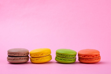 Traditional macaroon macaroon cookies on a pink background