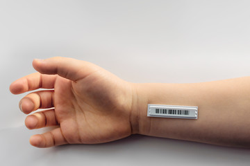 Bar code is on  the child hand. Copy space.  Clone of DNA and human genome. The concept child trafficking, digital concentration camps , electronic cards.