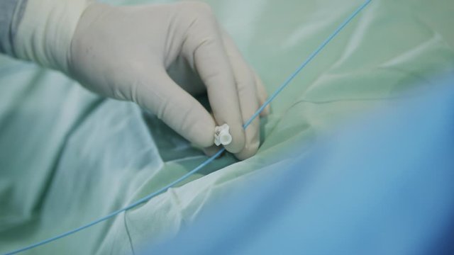Close up on Surgeon hand during a heart catheterization