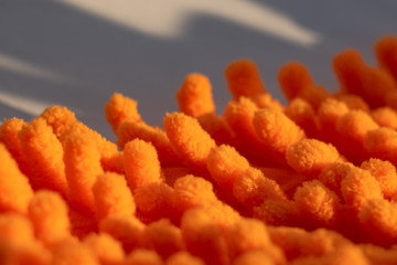 Microfiber texture with a soft large pile. Top view texture of orange big microfiber fabric towel