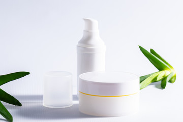 Set of natural moisturizing creams with aloe Vera extract on white background with fresh Aloe Vera leaves. Face care concept.