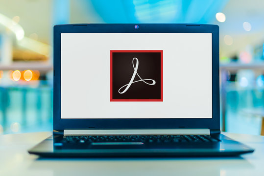 Laptop computer displaying logo of Adobe Acrobat