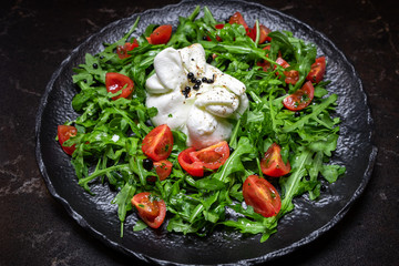 salad with herbs and cheese.red tomato