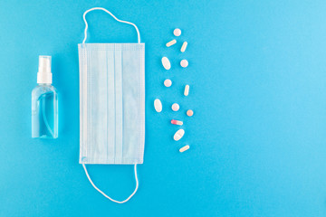 Fototapeta na wymiar A set of hygienic antiseptics and medications on a blue background.