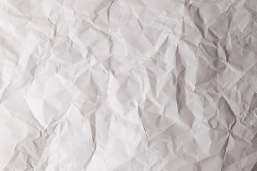 Crumpled white paper background.