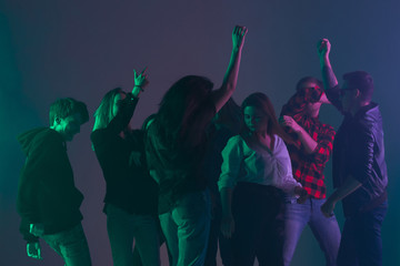 Cheering dance party, performance concept. Crowd shadow of people dancing with neon colorful lights...