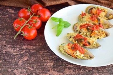 Baked mussels with parmesan cheese, tomato sauce and basil. Seafood. Shellfish mussels. 