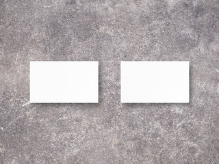 Mockup of two horizontal business cards. Mockup scene. Business cards on cement background. Photo mockup with clipping path.