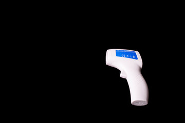 infrared thermometer on a black background. Coronavirus control, prevention